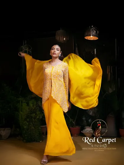 I love playing with vibrant colors, and this sunshine yellow three-piece set is a testament to that. The outfit features a fully sequined jacket, sharara pants, and a matching top, creating a look that is both artistic and full of energy.