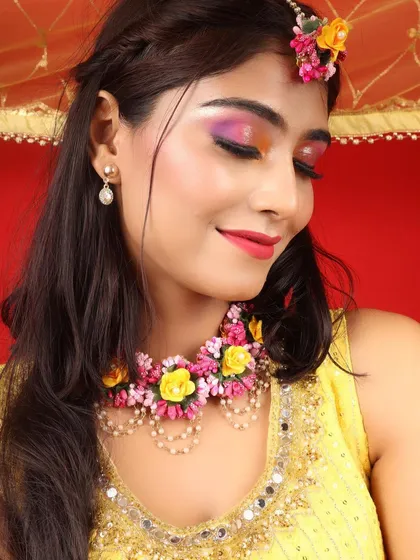 A colourful and creative Haldi makeup look. I used a blend of yellow, pink, and purple on the eyes to match the beautiful floral jewellery.