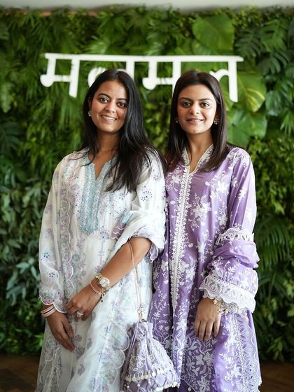 The founders of Shop Mul Mul posing in front of the custom green wall I designed for their collection launch.