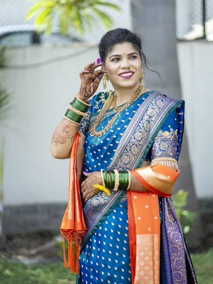 A happy and radiant bridal portrait, capturing her joy and the beauty of her wedding look.