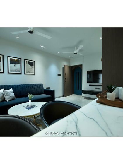 A view from the breakfast bar at Tulsi Heights, looking towards the living room. The layout is designed to be social, making it easy for the host to interact with guests while preparing food.