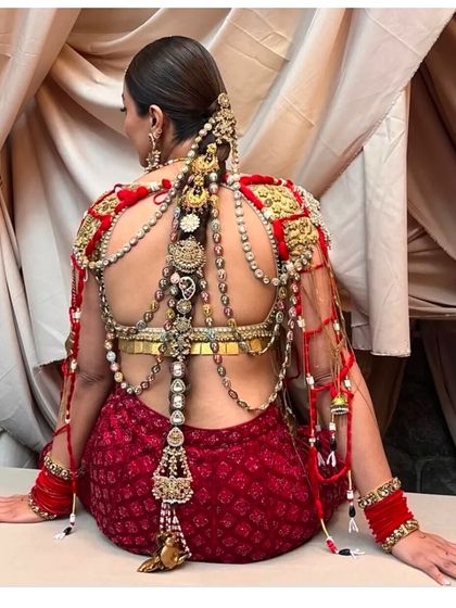 The bride seated, showcasing the full length and intricate detail of her one-of-a-kind jewelry braid.