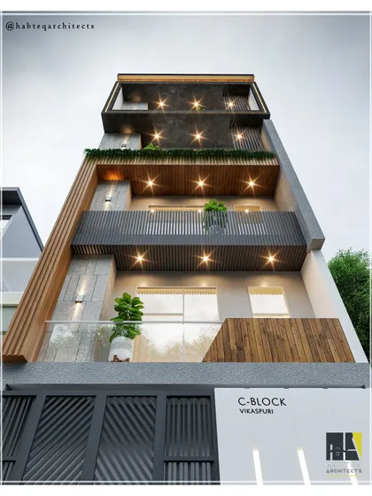 A night view of our upcoming residential project in Vikaspuri, highlighting the impact of strategic lighting. The combination of WPC louvers, grey tiles, and black MS railings creates a dramatic and sophisticated exterior after dark.
