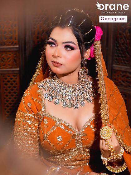 This powerful bridal look in a vibrant orange lehenga shows the versatility I teach. The makeup is bold yet elegant, designed to make a statement while maintaining a classic feel.