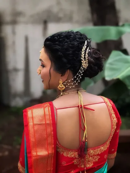 A close-up of the intricate hairstyle for our Maharashtrian bride. The braided bun is adorned with traditional accessories for a complete look.