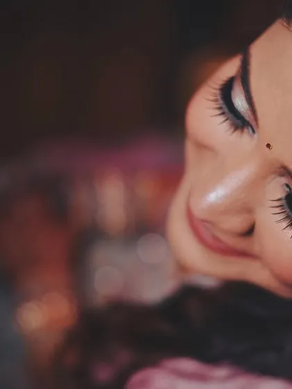 A detailed, artistic shot focusing on the bride's makeup. This highlights the skill of the makeup artist we work with and captures the beauty of the bridal look.
