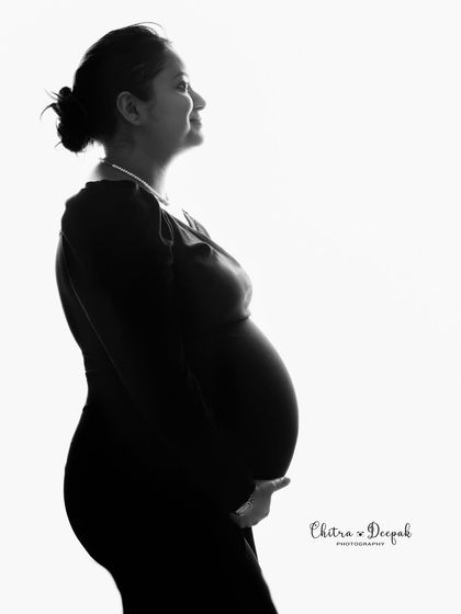 The beauty of simplicity. This clean, high-key silhouette against a white background is a timeless and elegant way to capture the shape of pregnancy.