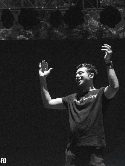 A black and white shot capturing a moment of interaction with the audience from the stage.