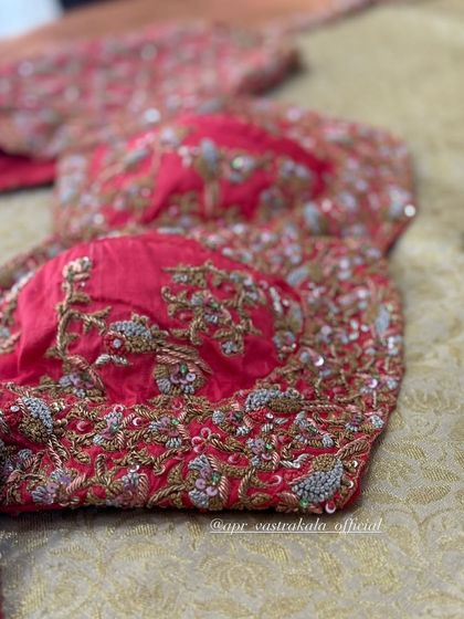 A red blouse with all-over floral embroidery, perfect for a bride.