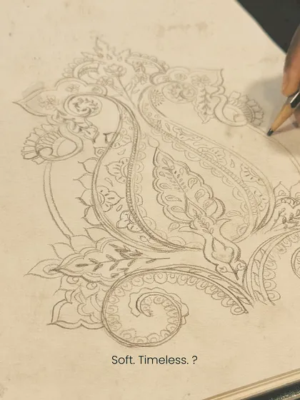 Every design starts with a sketch. This pencil drawing shows the initial exploration of a timeless paisley motif, capturing the soft, flowing lines that are characteristic of Kashmiri pashmina art.