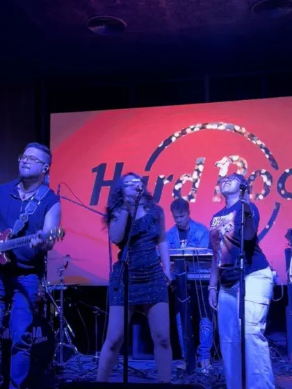 A photo from our show at Hard Rock Cafe in Chennai, with the iconic logo in the background. This reinforces our experience playing at well-known, respected venues.