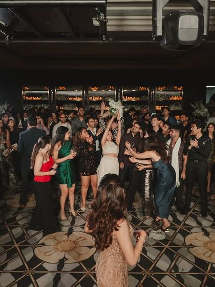A moment of pure fun during the after-party bouquet toss. We love incorporating the couple's wishes, like this modern twist on a classic tradition.