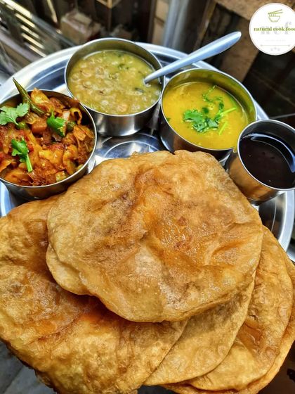 A traditional Manipuri breakfast of Tal (puri) served with ooti, lentils curry, and cabbage fry.