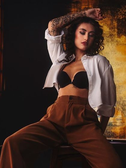 Sometimes the most powerful stories are told in the in-between moments. This raw, unfiltered shot uses moody, dramatic lighting to create a cinematic and fearless fashion portrait.