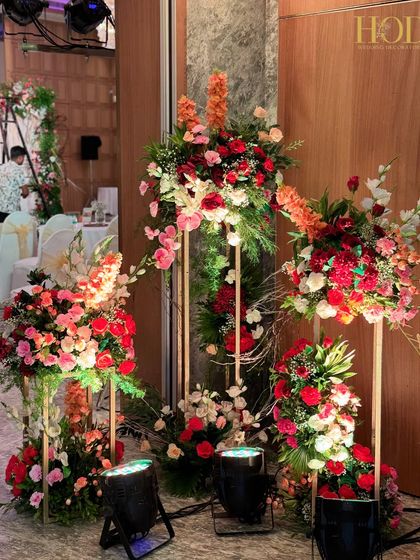 A wider shot of the floral stands, demonstrating how they frame the entrance and guide guests into the main celebration area with beauty and style.