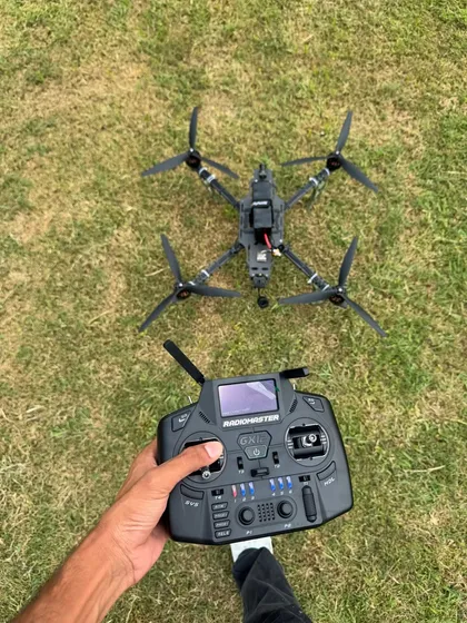 A point of view shot showing my FPV drone and the controller in my hand. This is my connection to the sky, the tool I use to capture the action.