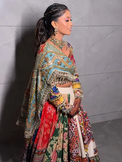 A side profile showcasing the braided ponytail, a practical and stylish choice for a night of Garba.