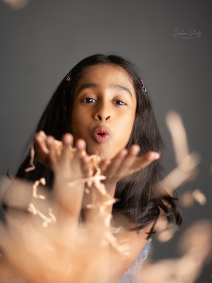 Blowing a kiss to the camera. This playful and interactive black and white shot is full of charm and personality.