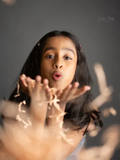 Blowing a kiss to the camera. This playful and interactive black and white shot is full of charm and personality.