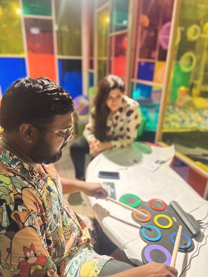 We encourage exploring a mix of traditional and modern instruments. This session shows a trainee experimenting with an electronic drum pad, discovering new ways to introduce rhythm and beats to children.