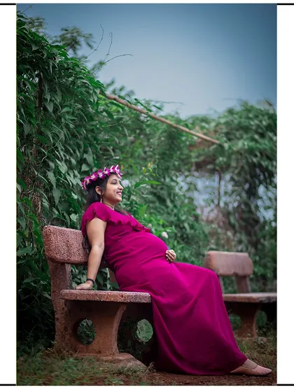 A relaxed solo portrait, with the mom-to-be sitting on a park bench and enjoying the peaceful surroundings.