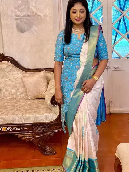Our client Prathima steals the show at her son’s wedding in a white and blue Kanchipuram silk saree, styled effortlessly with a chic jacket blouse. This is modern tradition at its finest.