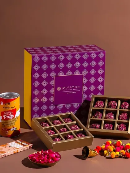 A festive hamper composition for Pullman New Delhi Aerocity, showcasing a mix of modern and traditional products.