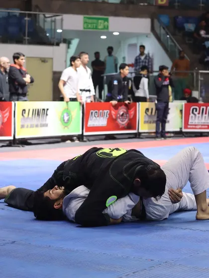 Securing a dominant side control position during a Gi match. From here, I can control the fight and set up my next attack.