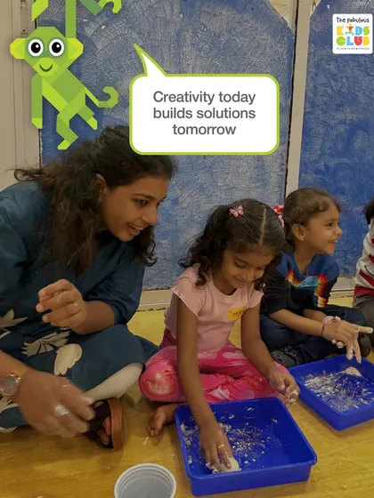 Creativity today builds solutions for tomorrow. Here, children are engaged in a sensory activity, learning through touch and collaboration in a guided, supportive environment.