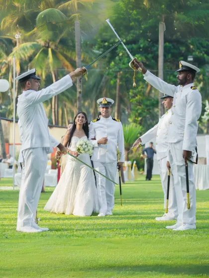 A unique and distinguished moment from a Navy wedding, where the couple walks through a traditional Arch of Sabers ceremony. This photo highlights my experience in capturing specialized and meaningful traditions with elegance.