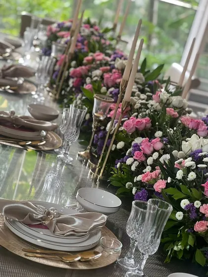 We transform spaces into elegant dining experiences. For this sit-down lunch, we created a stunning floral runner with tapered candles, setting a sophisticated and intimate tone for the guests.