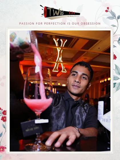 A bartender pours a beautiful pink cocktail, capturing the elegance of the Art of Time 10th-anniversary event.