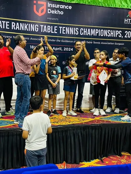 The awards ceremony in full swing. This photo captures the moment Prisha and Keshava were recognized on stage for their achievement at the state-level tournament, a proud moment for them and our academy.