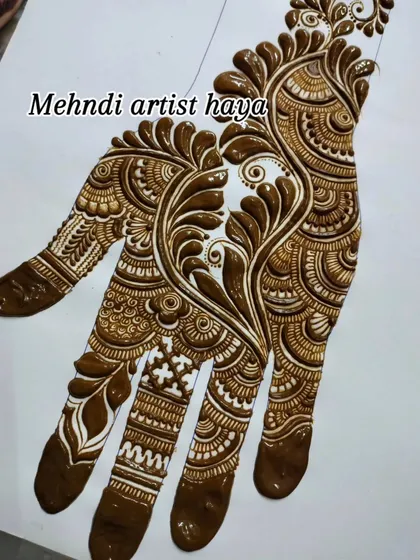A practice sheet showing a bold, flowing design dominated by paisley and vine elements. This style is often called "Arabic" or "Gulf" henna.