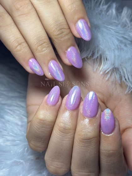 A beautiful set of iridescent lilac nails with a mesmerizing shimmer and a touch of holographic glitter.