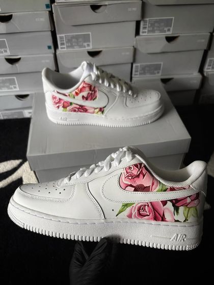 A custom Nike Air Force 1 with a beautiful pink rosé floral pattern on the side panels.