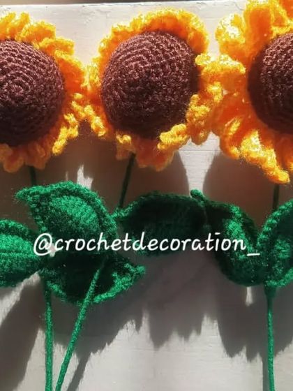 Three single sunflower stems, showing slight variations that make each handmade flower unique.