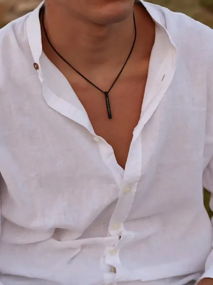 This black bar pendant, engraved with coordinates, offers a subtle and modern way to carry a special place with you. The black finish provides a unique, understated look.