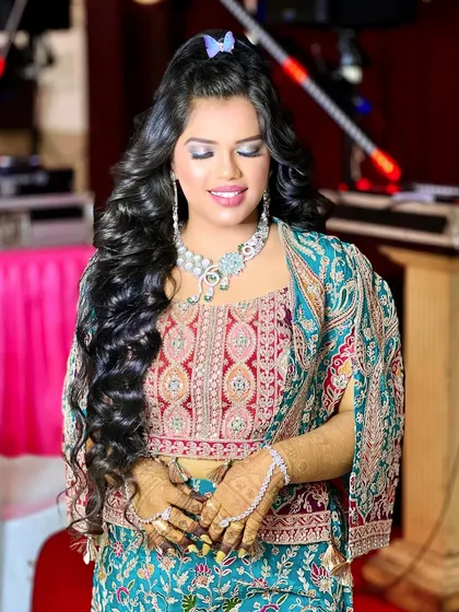 A serene, eyes-closed shot that highlights the glamorous makeup and the beautiful diamond necklace.