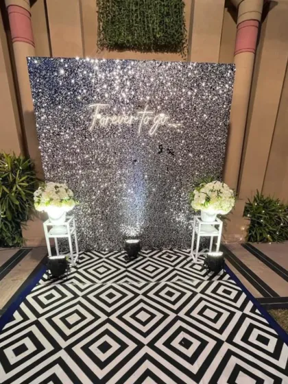 Another angle of the trendy silver sequin photo wall, a popular choice for modern receptions.