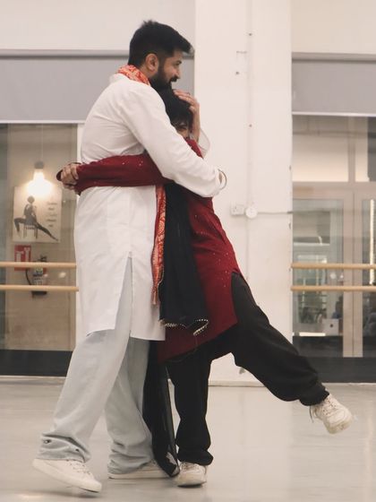 A heartfelt hug during a birthday workshop, with everyone dressed in traditional attire. This image captures the emotion and connection that dance brings to celebrations.