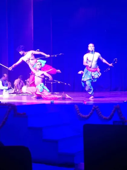An action sequence from a group performance, showcasing leaps and dynamic poses with weapons. This highlights the athletic and acrobatic nature of Mayurbhanj Chhau.