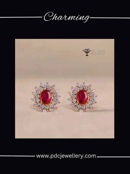 A charming pair of 18kt hallmarked gold earrings, featuring a central oval ruby surrounded by a halo of brilliant diamonds. A classic and colourful design.