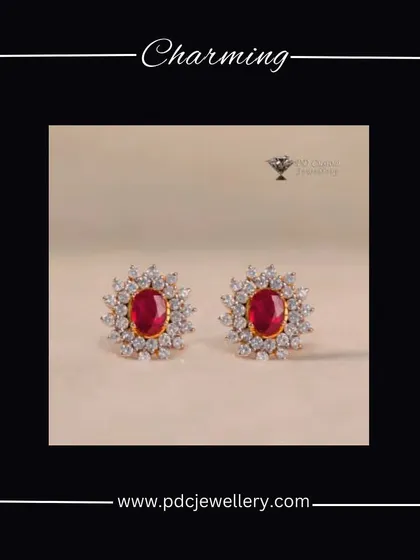 A charming pair of 18kt gold earrings featuring a central ruby surrounded by a halo of diamonds. These classic studs are perfect for adding a touch of color and elegance.