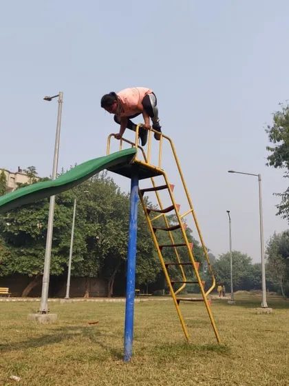 Having some fun with Bakasana, or crow pose, on top of a slide. This arm balance requires significant core engagement, arm strength, and a bit of playful courage.
