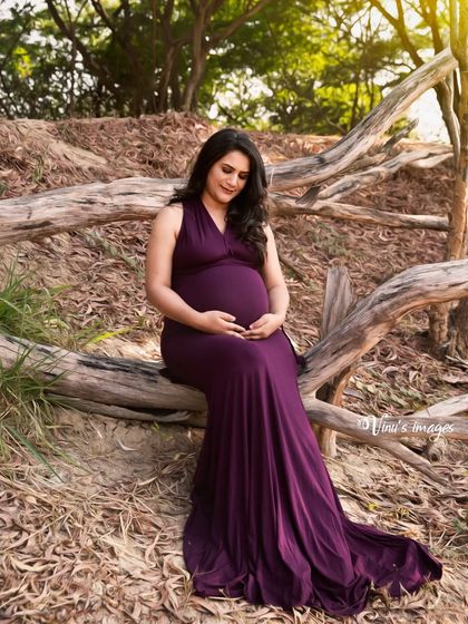 A slightly different angle of the same peaceful pose, capturing the mother's gentle expression as she cradles her bump.