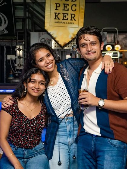 A group of friends enjoying drinks by the bar.