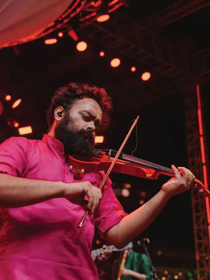 A live performance by a violinist from The Raghu Dixit Project. High-quality live music elevates the atmosphere of any event, making it feel truly special and sophisticated.