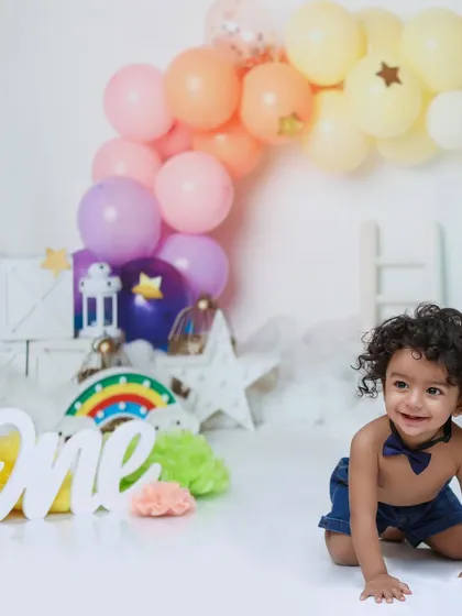Capturing the movement and energy of a one-year-old, this photo shows the little boy mid-crawl during his fun and colorful birthday session.