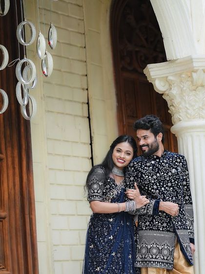 A close-up of the couple in front of the arched doorway, highlighting their connection.